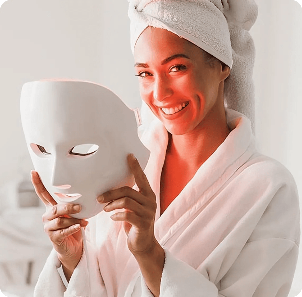 Woman using LED red light therapy face mask for skin rejuvenation